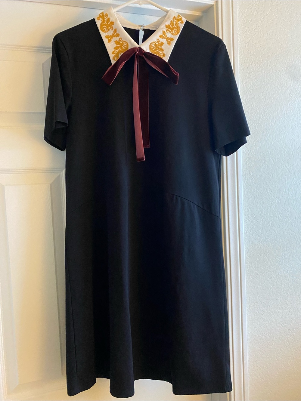 Zara Black Dress with White & Gold Embroidered Collar and Burgundy Bow